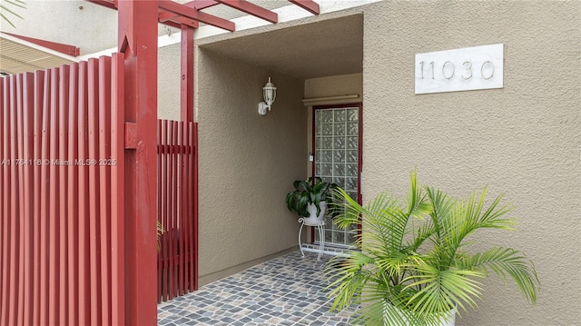 doorway to property with stucco siding