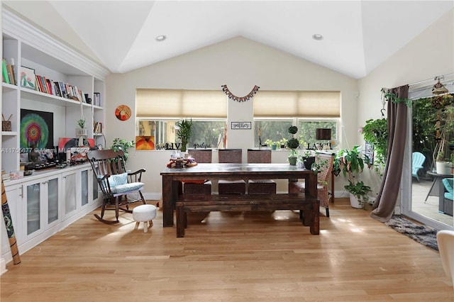 dining area with recessed lighting, light wood finished floors, and vaulted ceiling