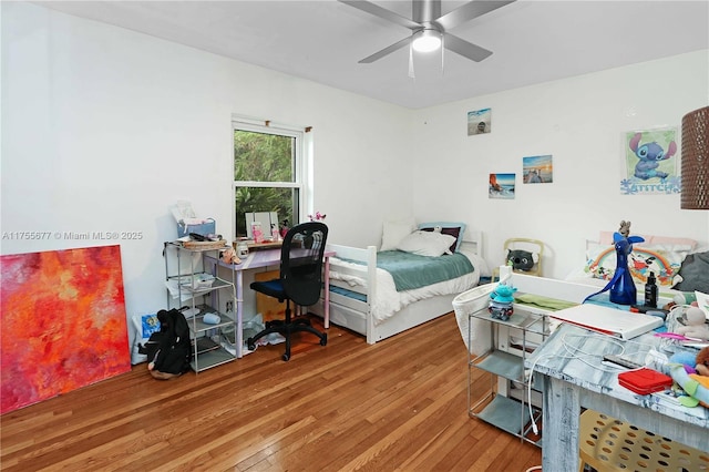 bedroom with hardwood / wood-style floors and a ceiling fan