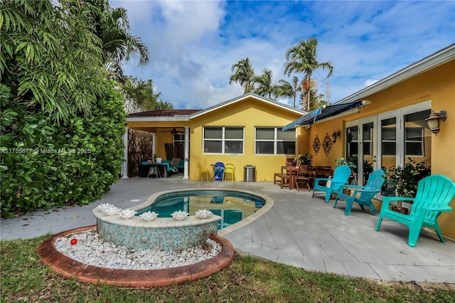 rear view of property featuring a patio area and stucco siding