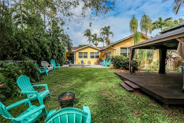 view of yard featuring a gazebo, a patio area, and an outdoor fire pit