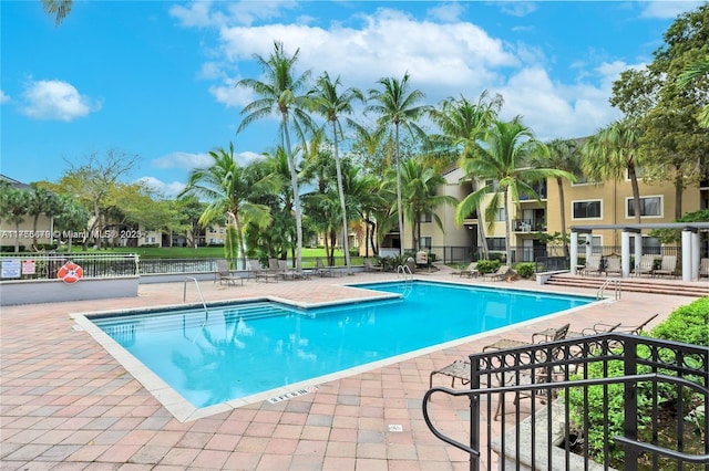 pool featuring a patio and fence