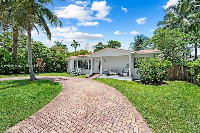 225 191st Ter, Sunny Isles Beach, FL 33160 - single story home with curved driveway and stucco siding