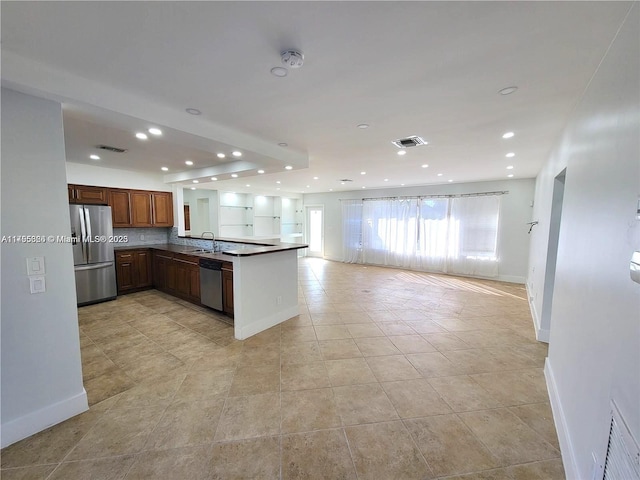 225 191st Ter, Sunny Isles Beach, FL 33160 - kitchen featuring appliances with stainless steel finishes, open floor plan, a peninsula, light tile patterned floors, and recessed lighting