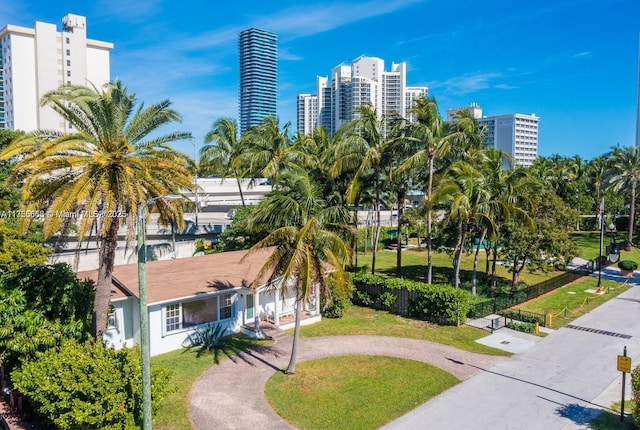 225 191st Ter, Sunny Isles Beach, FL 33160 - view of community with a city view, curved driveway, and a yard