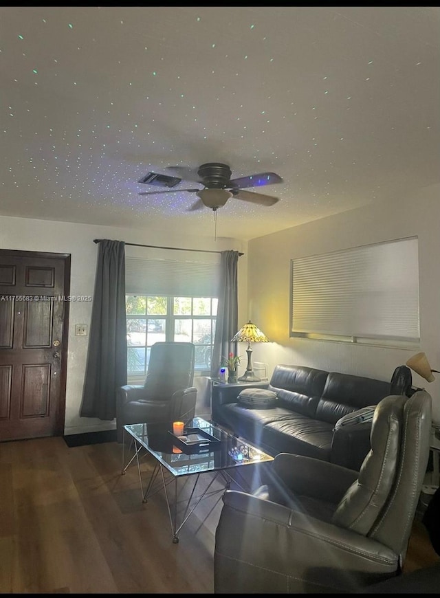 living area with ceiling fan and wood finished floors