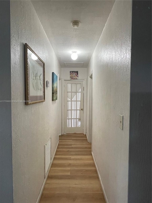 3611 SW 36th St, West Park, FL 33023 - hallway featuring a textured wall and light wood-type flooring