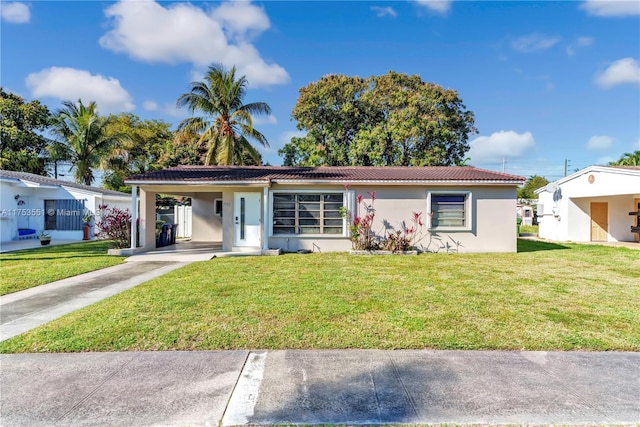 view of front of house featuring concrete driveway, stucco siding, a tile roof, a carport, and a front yard