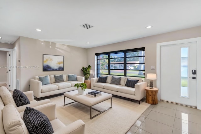 living area with light tile patterned floors, visible vents, and recessed lighting