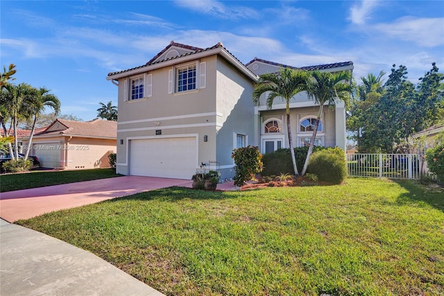 view of front facade with an attached garage, fence, concrete driveway, stucco siding, and a front yard