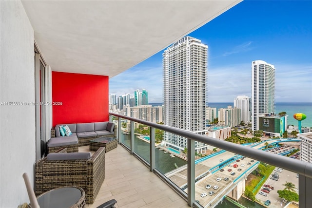 balcony featuring a water view and a city view