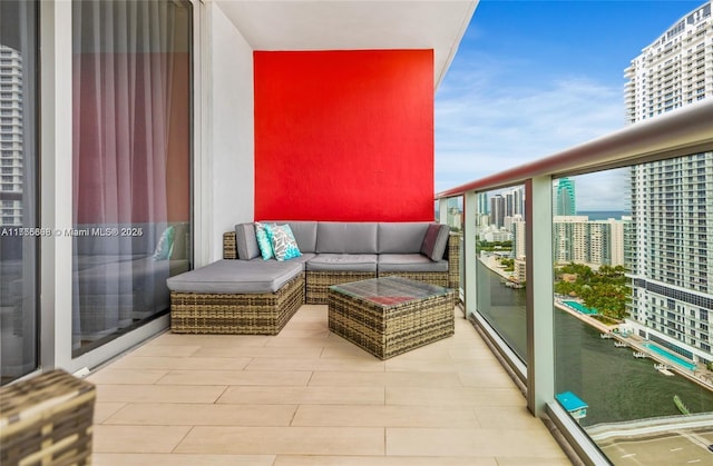 balcony featuring outdoor lounge area, a sunroom, and a city view