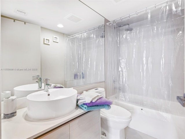 bathroom with visible vents, toilet, vanity, and shower / tub combo