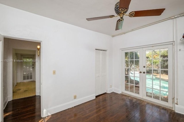 unfurnished room with a ceiling fan, baseboards, wood finished floors, and french doors