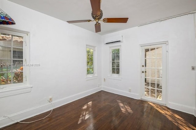 unfurnished room featuring a ceiling fan, wood finished floors, baseboards, and a wall mounted AC