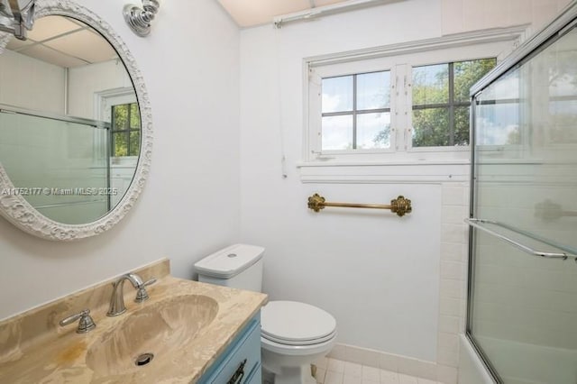 full bathroom with shower / bath combination with glass door, vanity, toilet, and tile patterned floors