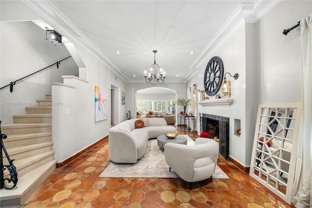 living area featuring arched walkways, crown molding, stairway, a high end fireplace, and a chandelier