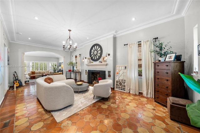 living area featuring recessed lighting, a fireplace, arched walkways, and ornamental molding