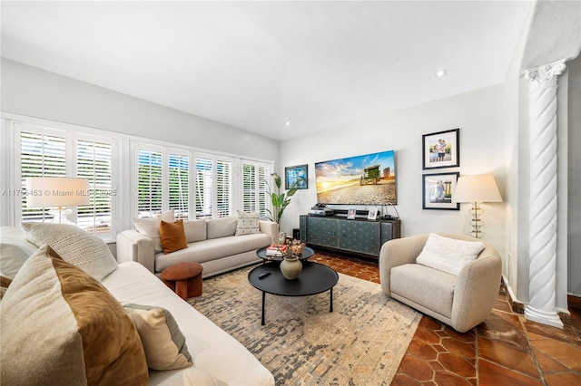 living room with decorative columns and recessed lighting