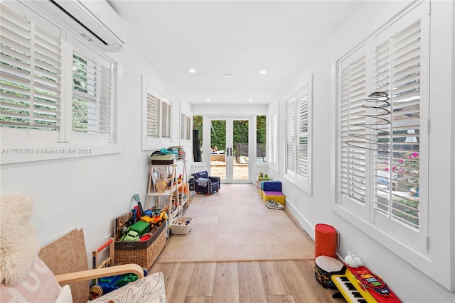 sunroom / solarium featuring french doors and a wall mounted air conditioner