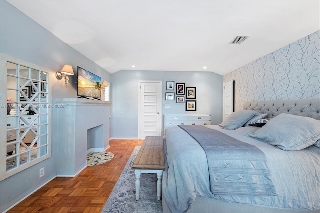 bedroom with an accent wall, a fireplace, visible vents, baseboards, and wallpapered walls