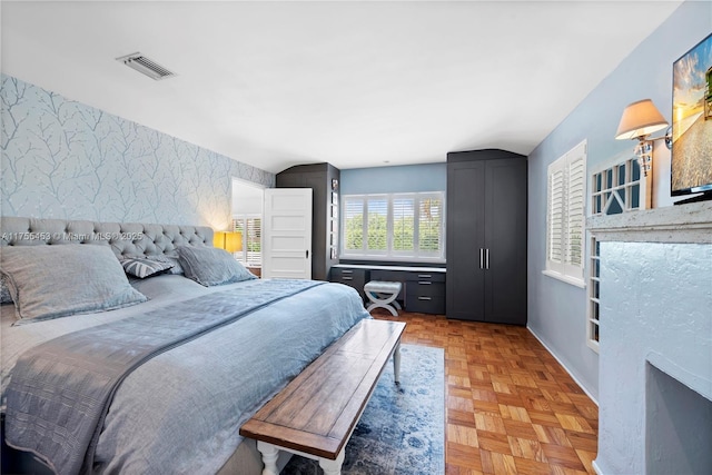 bedroom featuring visible vents and wallpapered walls