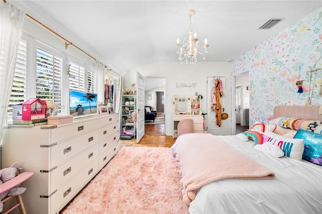 bedroom featuring lofted ceiling, visible vents, light wood-style floors, a chandelier, and wallpapered walls