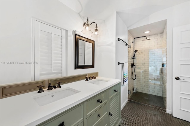 bathroom with a stall shower, a sink, and double vanity