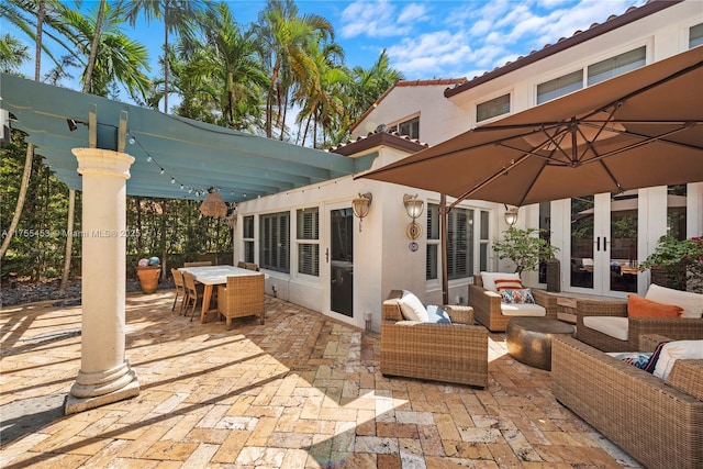 view of patio featuring outdoor dining space, french doors, outdoor lounge area, and a pergola