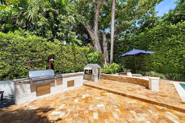 view of patio / terrace featuring exterior kitchen and area for grilling