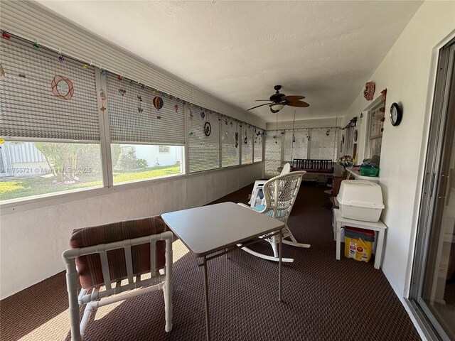 sunroom featuring ceiling fan