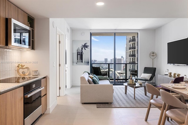 living room featuring expansive windows and baseboards