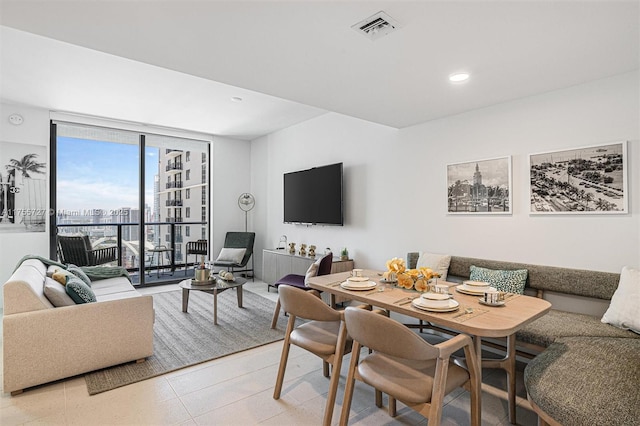 dining area with expansive windows, breakfast area, visible vents, and recessed lighting