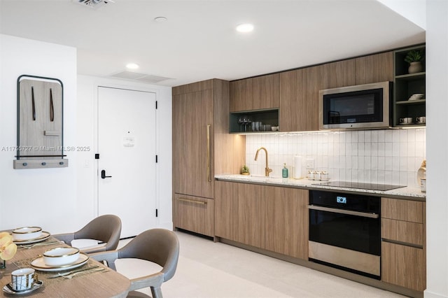 kitchen with black appliances, modern cabinets, open shelves, and decorative backsplash