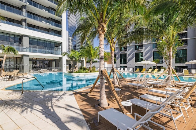 community pool featuring fence and a patio