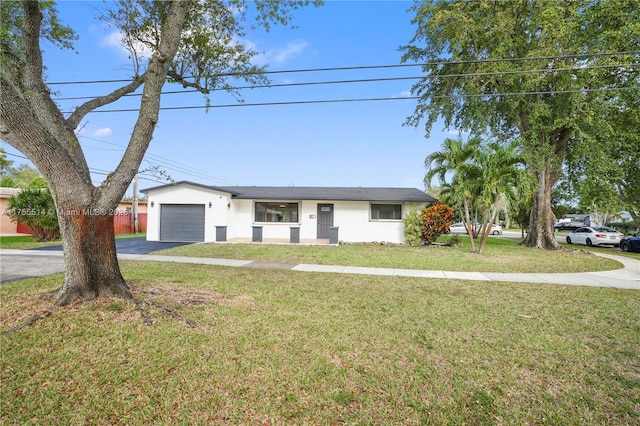 ranch-style house with a garage, a front yard, driveway, and stucco siding