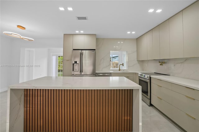 5280 SW 90th Ave, Cooper City, FL 33328 - kitchen with stainless steel appliances, modern cabinets, a sink, decorative backsplash, and light marble finish flooring