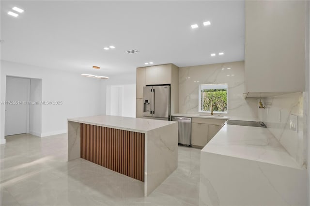 5280 SW 90th Ave, Cooper City, FL 33328 - kitchen featuring appliances with stainless steel finishes, modern cabinets, a kitchen island, recessed lighting, and light marble finish floors