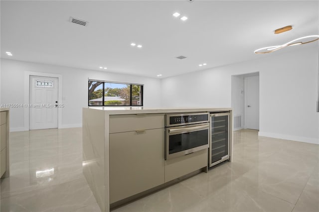 5280 SW 90th Ave, Cooper City, FL 33328 - kitchen with wine cooler, stainless steel oven, modern cabinets, recessed lighting, and light countertops