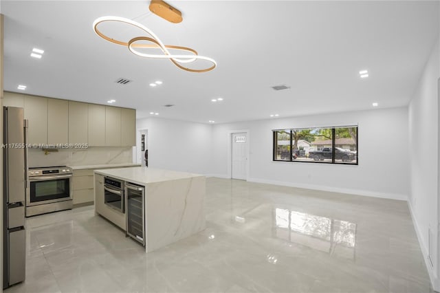 5280 SW 90th Ave, Cooper City, FL 33328 - kitchen with beverage cooler, modern cabinets, stainless steel appliances, light marble finish floors, and a kitchen island