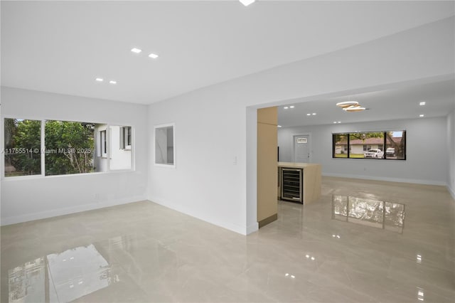 5280 SW 90th Ave, Cooper City, FL 33328 - spare room with beverage cooler, light marble finish flooring, recessed lighting, baseboards, and bar area