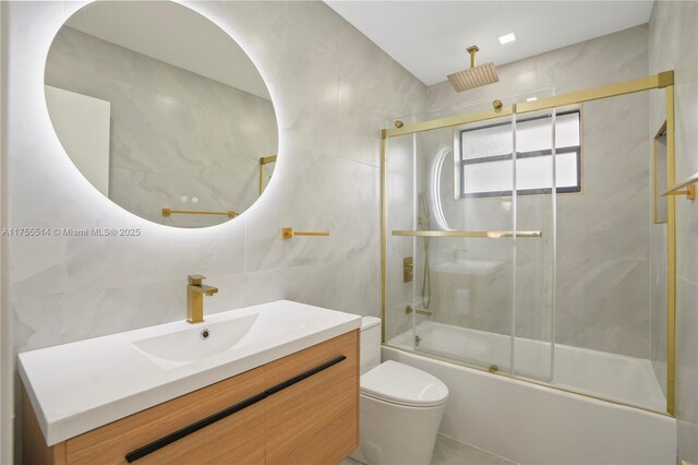 5280 SW 90th Ave, Cooper City, FL 33328 - bathroom featuring tile walls, vanity, a combined bath / shower with rainfall shower, and toilet