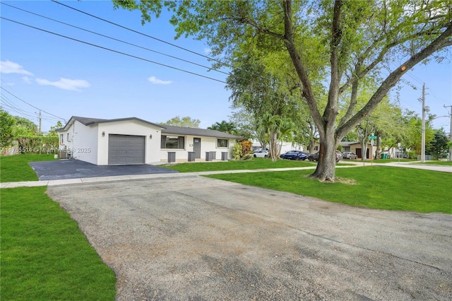 5280 SW 90th Ave, Cooper City, FL 33328 - view of front facade featuring a garage, stucco siding, asphalt driveway, and a front lawn