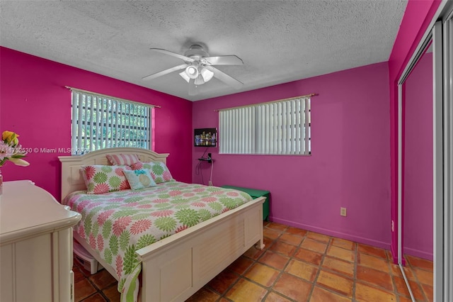 bedroom featuring a textured ceiling and a ceiling fan