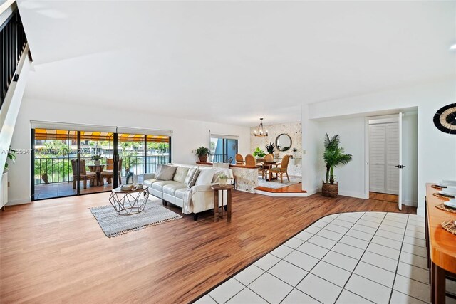 16408 Bridge End Rd, Miami Lakes, FL 33014 - living area featuring baseboards, light wood-style flooring, and a notable chandelier