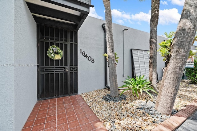 16408 Bridge End Rd, Miami Lakes, FL 33014 - view of exterior entry featuring stucco siding