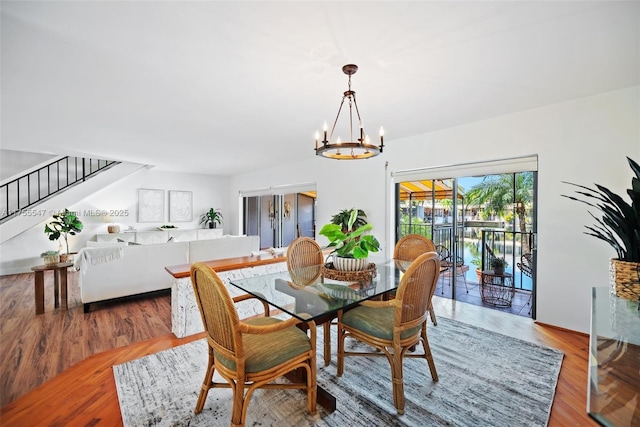 16408 Bridge End Rd, Miami Lakes, FL 33014 - dining room with a chandelier, stairs, and wood finished floors