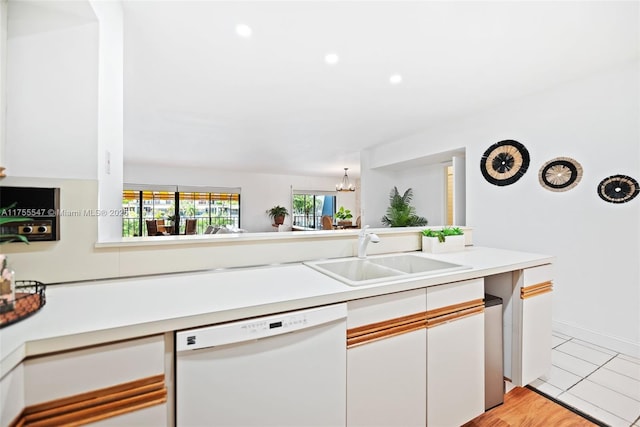 16408 Bridge End Rd, Miami Lakes, FL 33014 - kitchen with white cabinetry, light countertops, an inviting chandelier, a sink, and white dishwasher