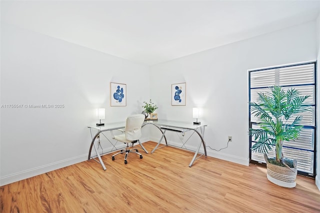 office area with light wood-style floors and baseboards