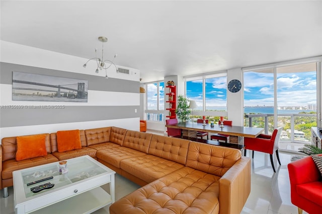 living area featuring a wealth of natural light, visible vents, and an inviting chandelier